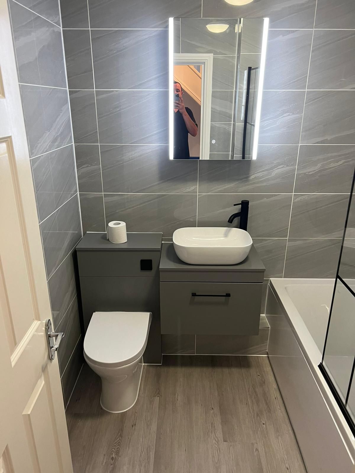Compact bathroom with a sage vanity unit and countertop basin