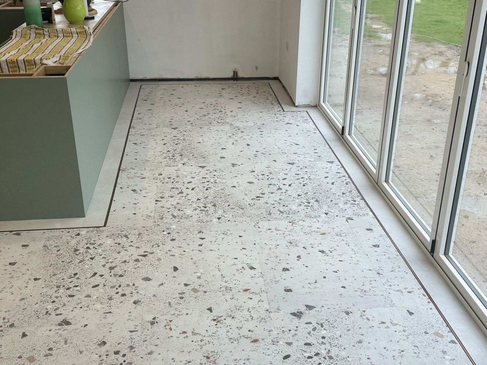 Terrazzo-style luxury vinyl flooring by bifold doors