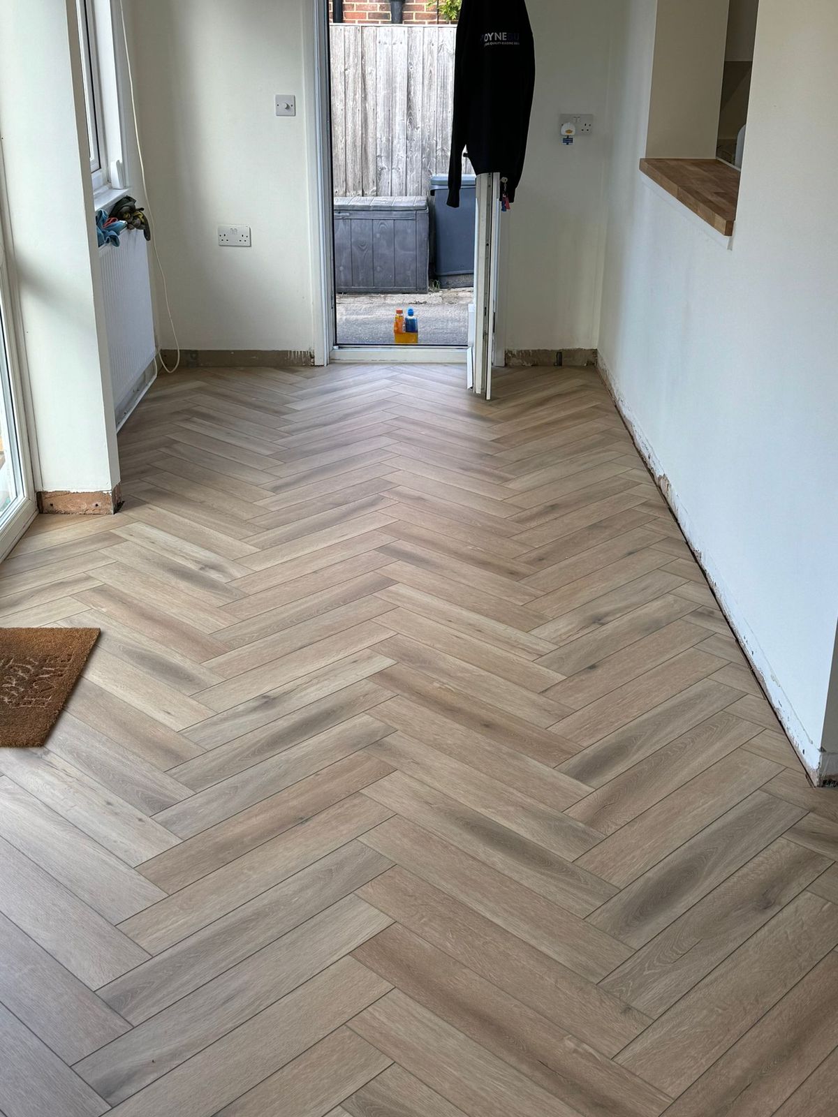 Oak herringbone flooring flowing into a kitchen-diner