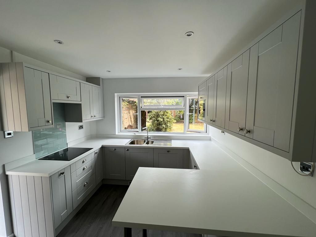 Grey shaker kitchen with white quartz worktops