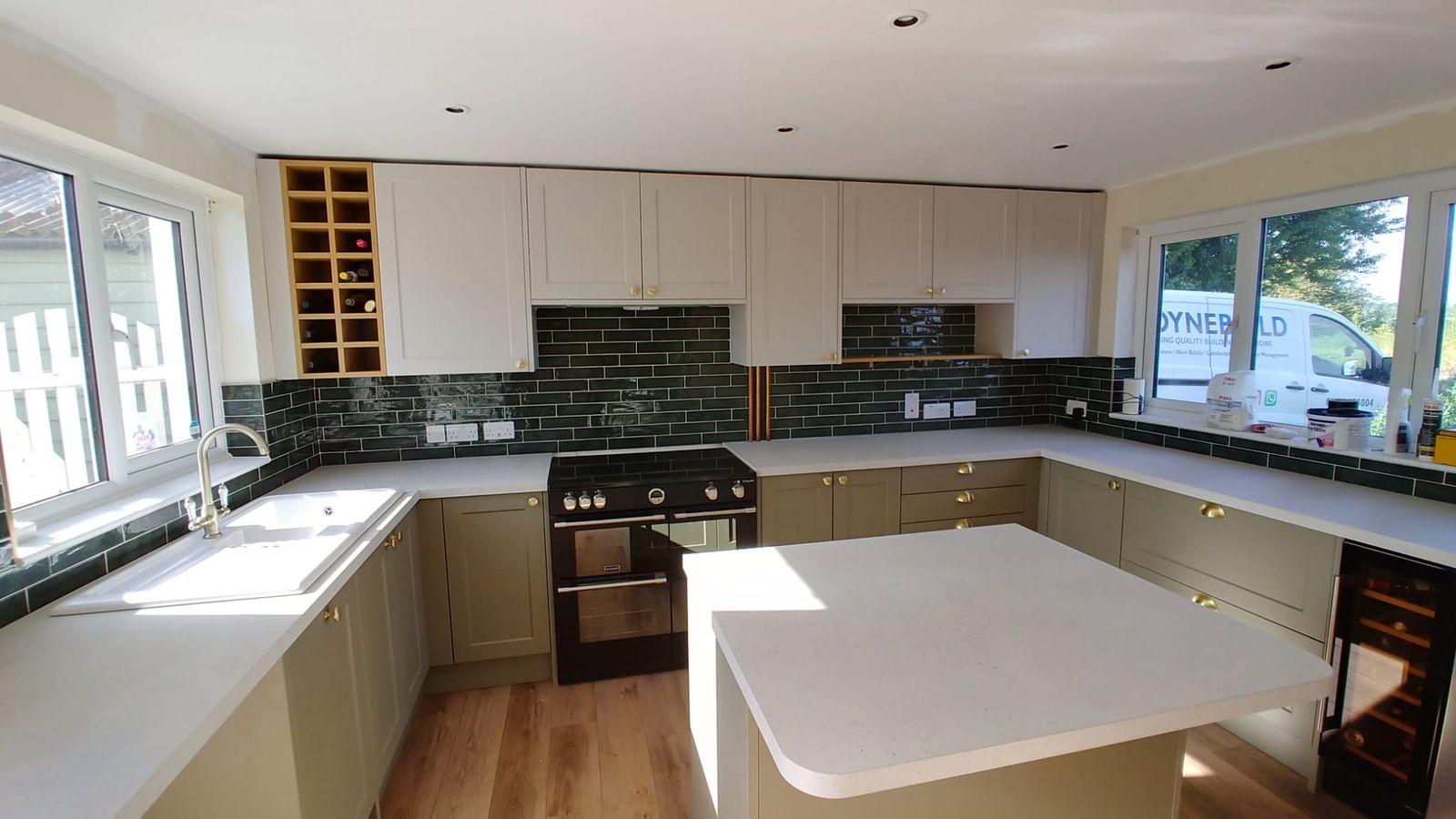 White island kitchen with a green metro tile splashback