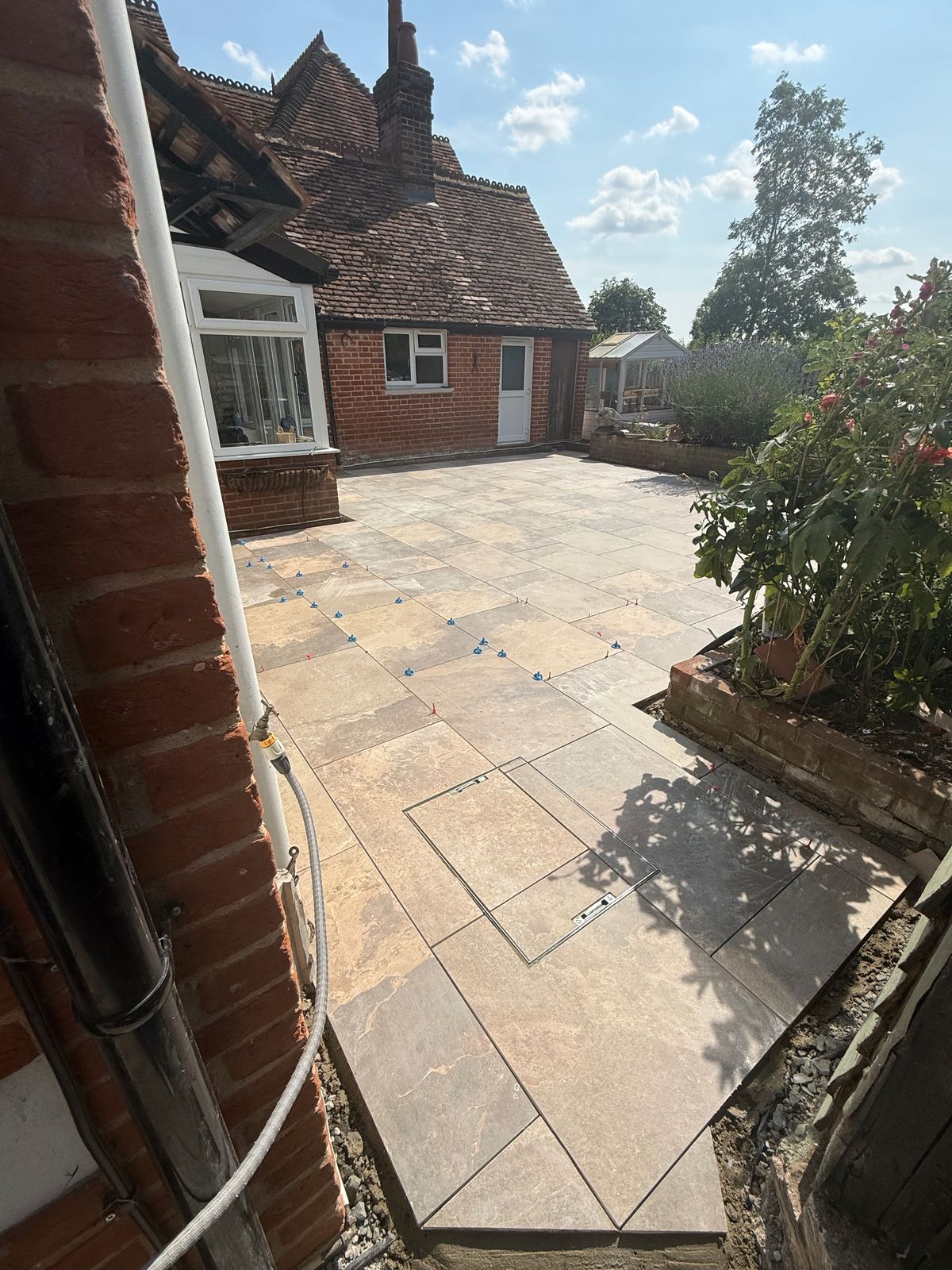 Cream porcelain patio laid to a rear garden