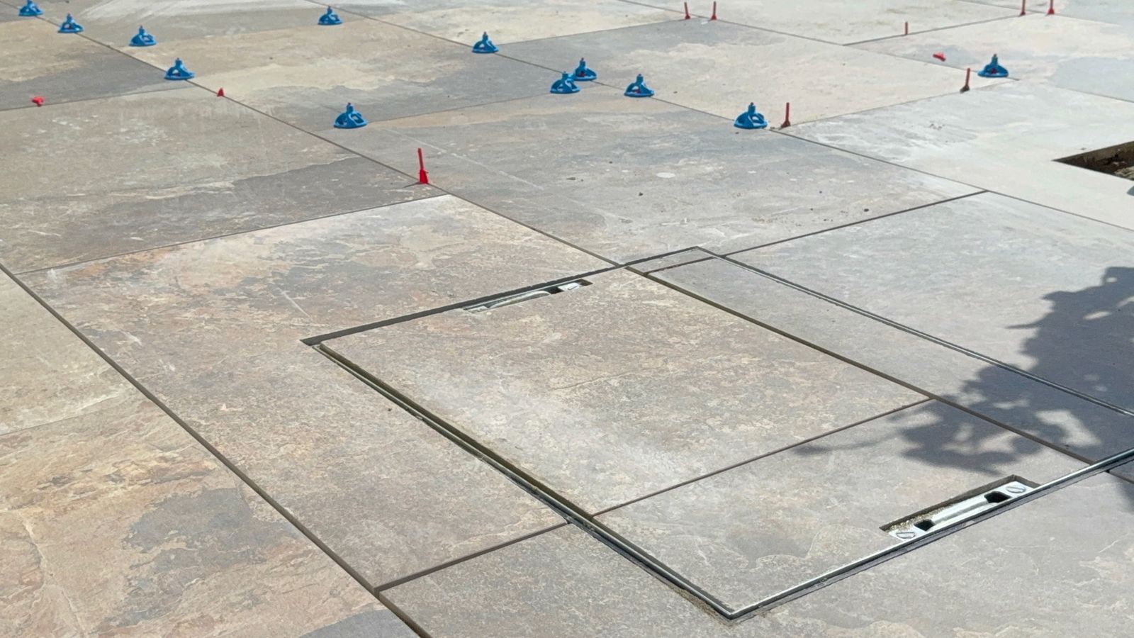 Porcelain paving being levelled and laid