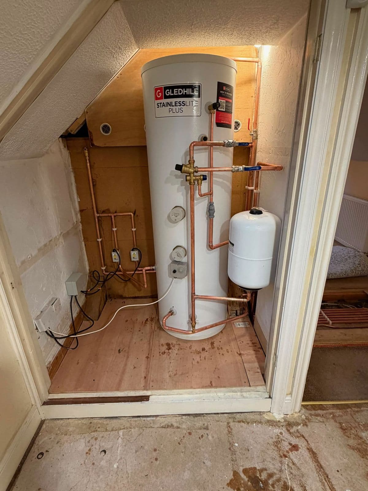 Unvented hot water cylinder installed with neat copper pipework by Coyne Plumbing